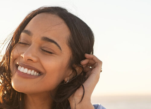 Young woman with acne scars at the beach