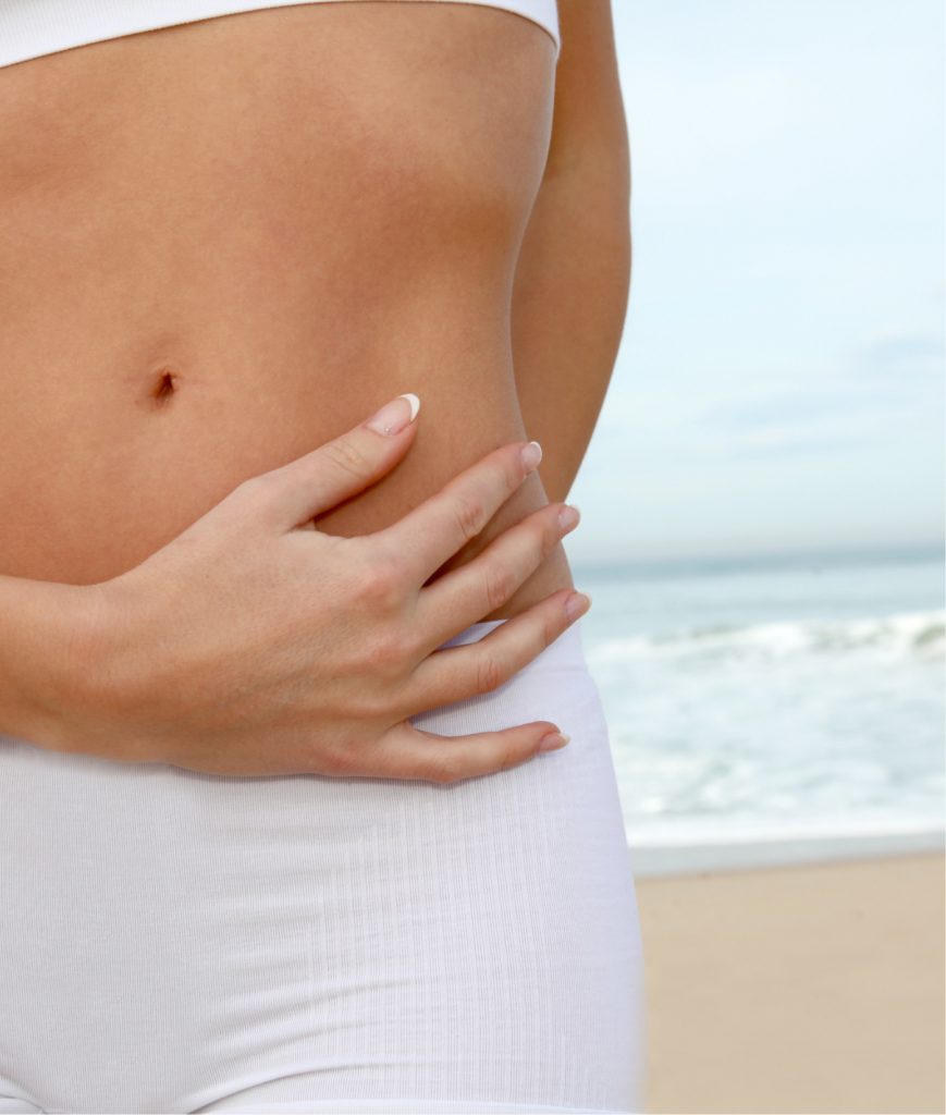 Image of a person's torso with the beach in the background