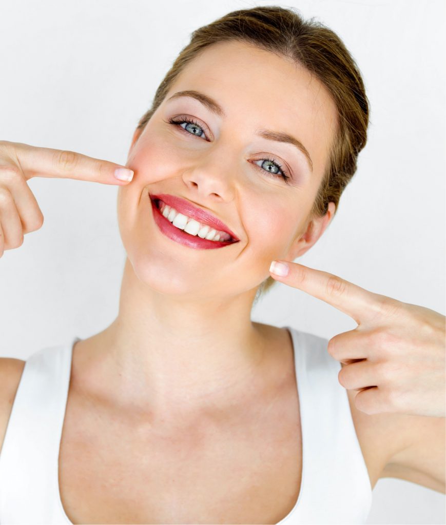 Woman pointing at her face