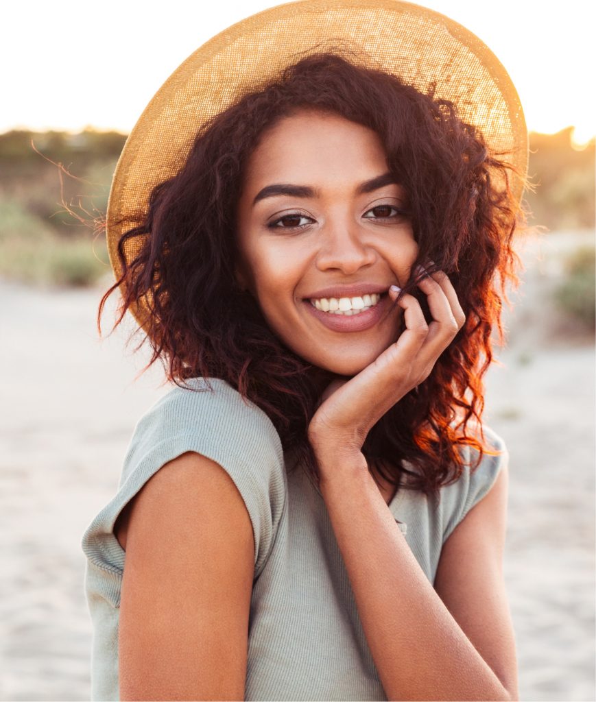 Happy young woman at the beach