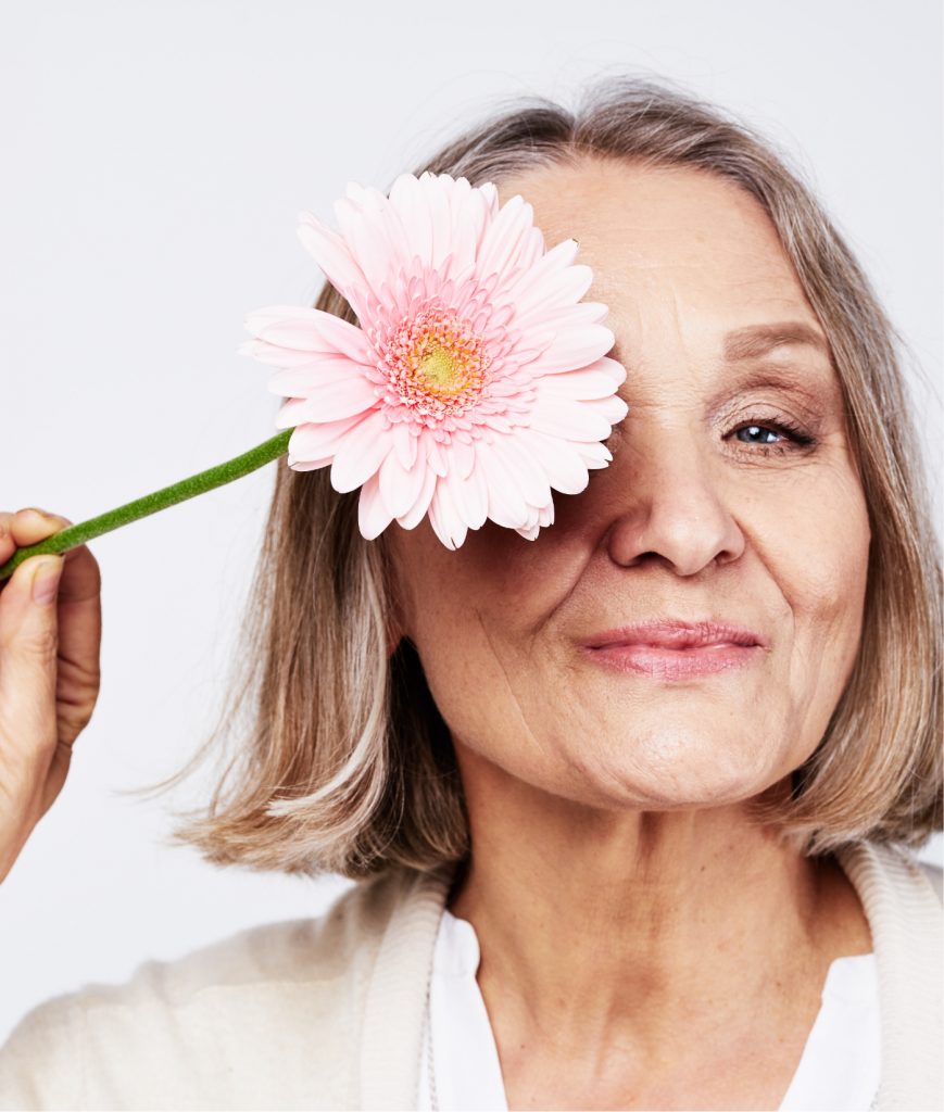 Older woman holding a flower