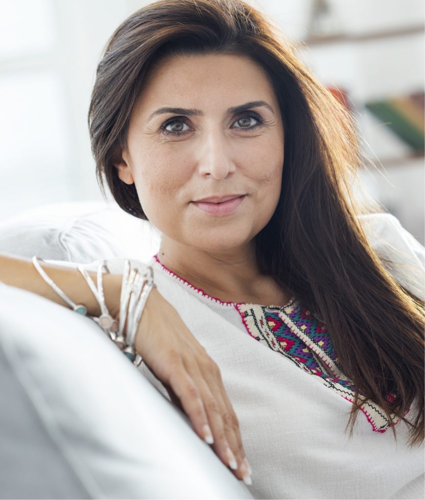 Brunette woman sitting on a couch