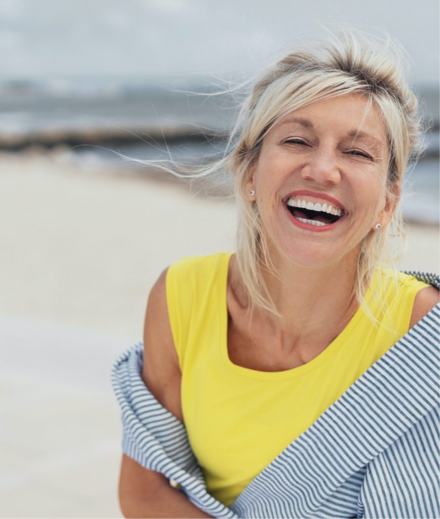 Happy older woman at the beach