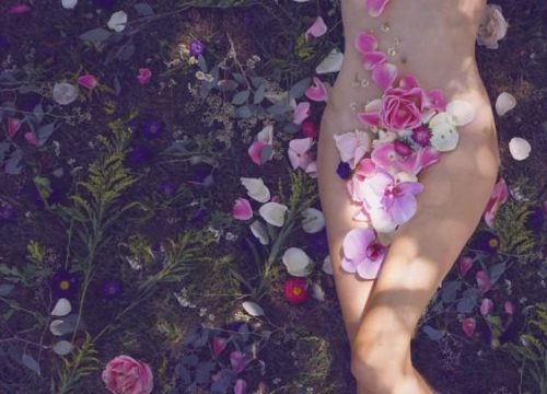 Woman lying in flowers