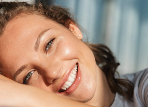 Smiling woman lying down on her side