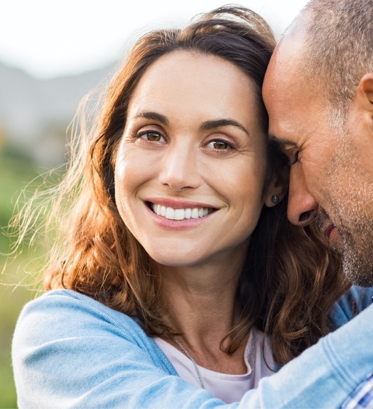 Smiling woman hugging her husband