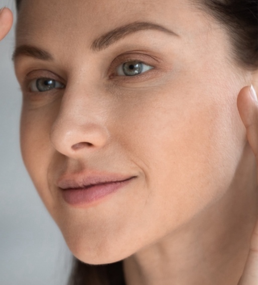 Woman examining the skin on her face