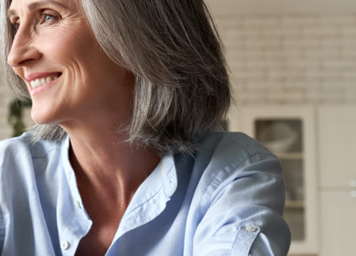 Woman with gray hair and a blue button up