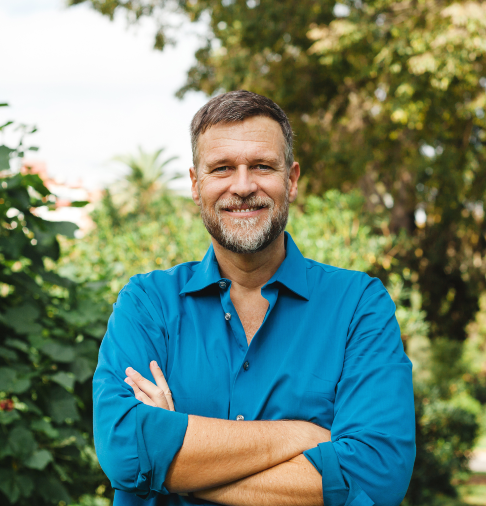 Man in blue shirt crossing his arms