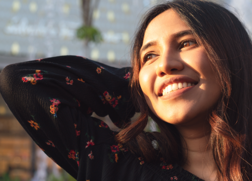 Smiling woman looking in the direction of the sun