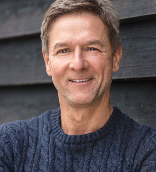 Closeup of a man in a blue sweater