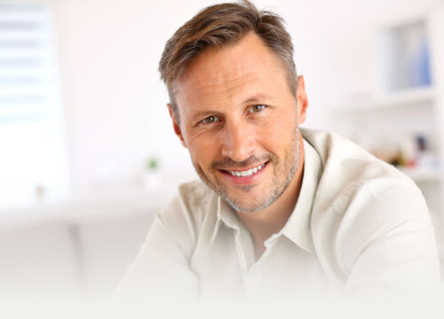 Smiling man sitting in his living room