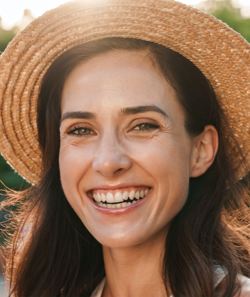 Photo of a happy woman wearing a straw hat