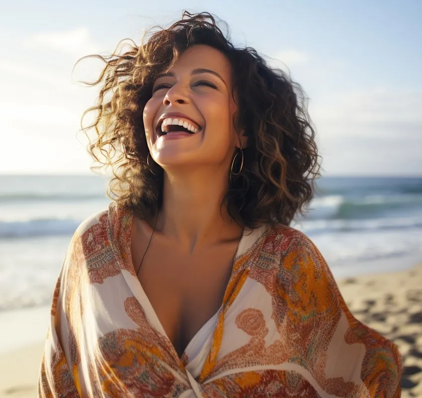 Happy middle-aged woman at the beach